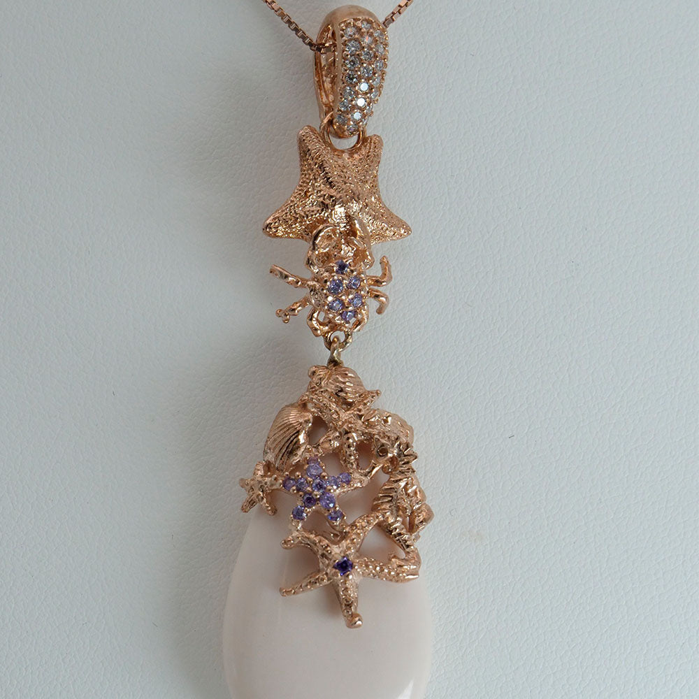 Collana in argento rosato con zirconi e pasta di corallo